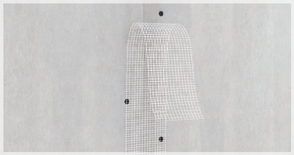 stricking glass fibre tape on  a joint of plasterboards